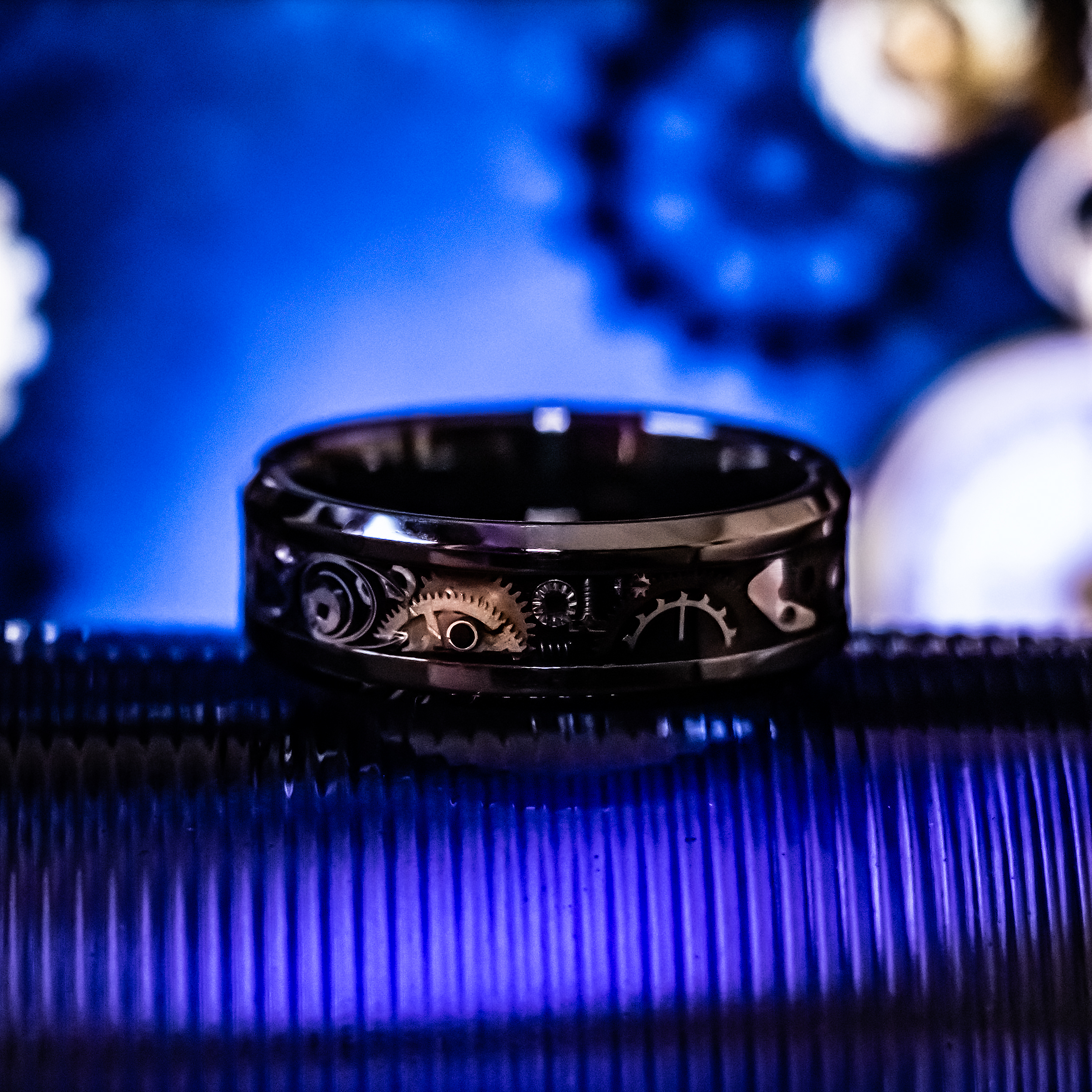 steampunk themed ceramic Ring made of watch parts with blue background